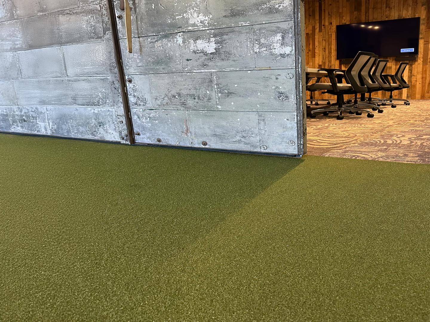A meeting room and industrial sliding door with RageTurf installed