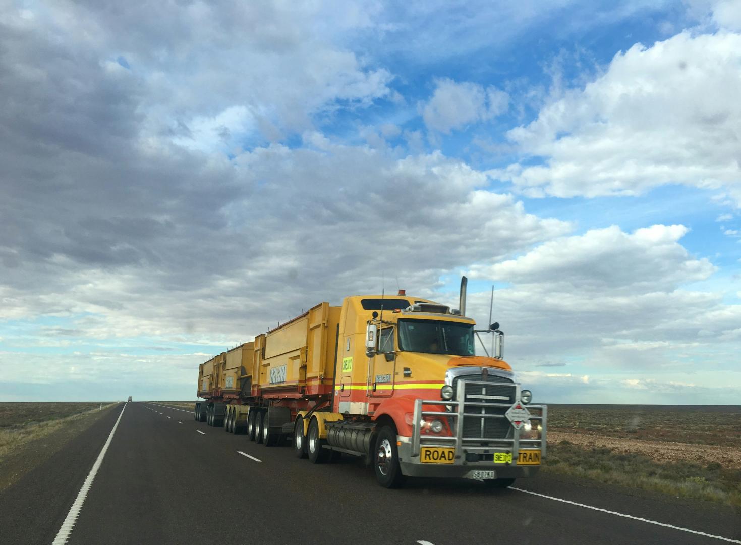 A large semi truck driving down the road